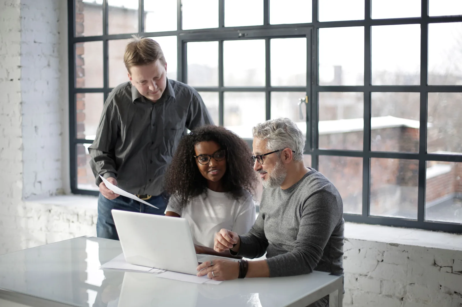 Business support team collaborating at a workstation